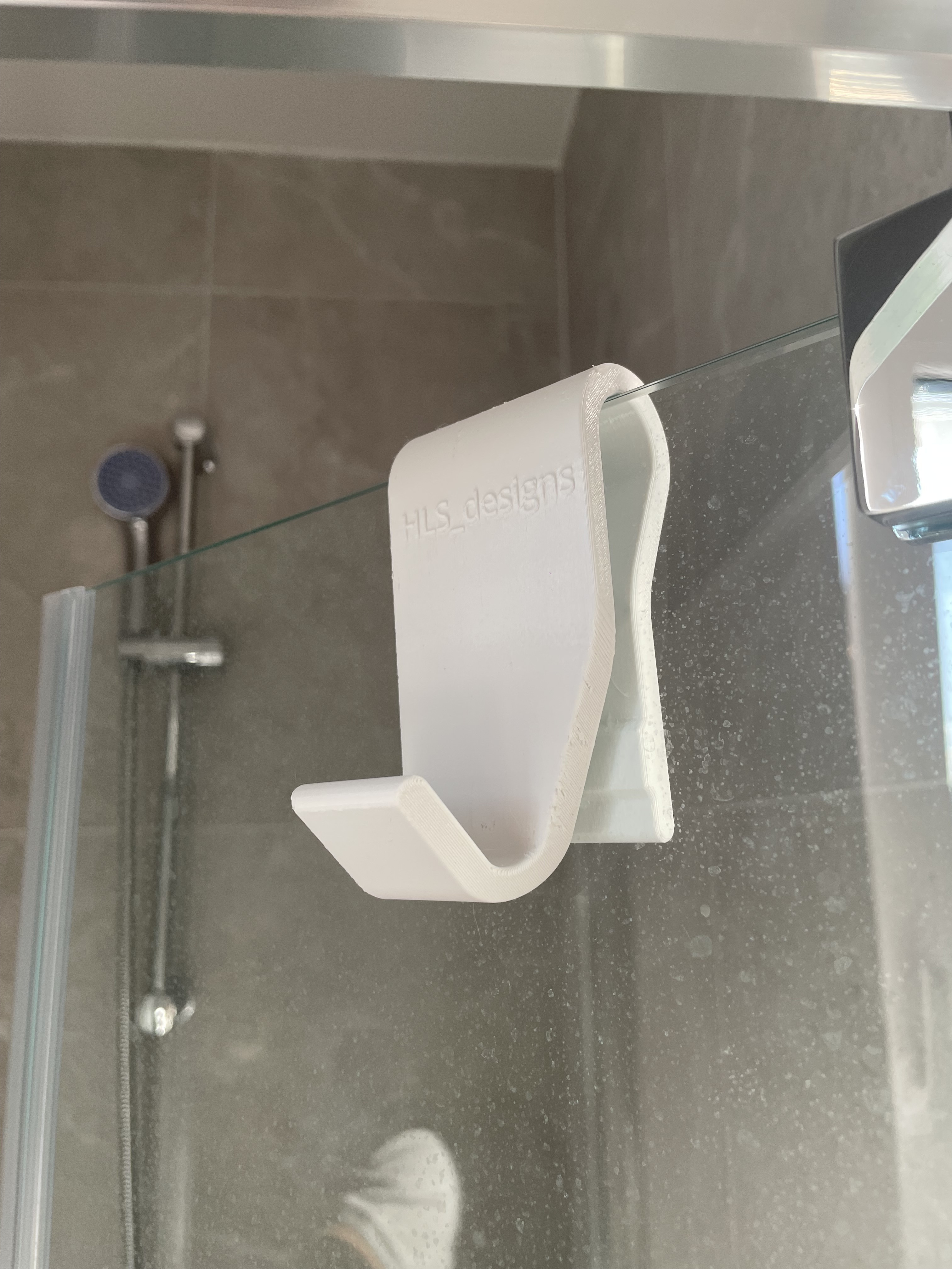 Sliding towel hook for glass shower doors